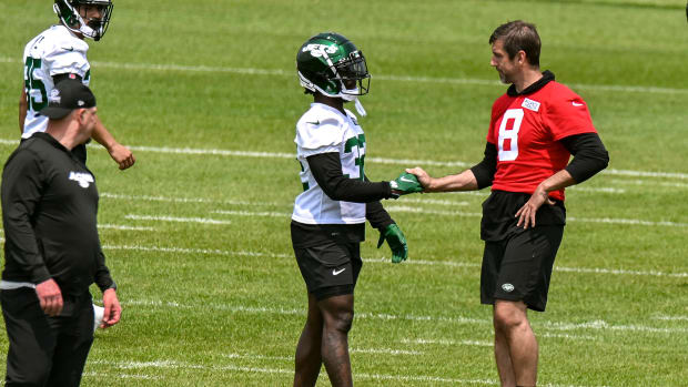 RB Michael Carter (32) and QB Aaron Rodgers (8) at Jets' OTAs